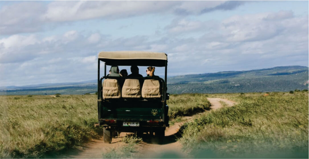 Jeep safari vehicle on a dirt road with a scenic landscape in the background on memorable Samburu Kenya safari game drives
