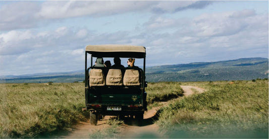 Jeep safari vehicle on a dirt road with a scenic landscape in the background on memorable Samburu Kenya safari game drives