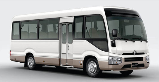 White group shuttle bus safari transfer bus with a visible Toyota logo on a gray background