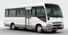 White group shuttle bus safari transfer bus with a visible Toyota logo on a gray background